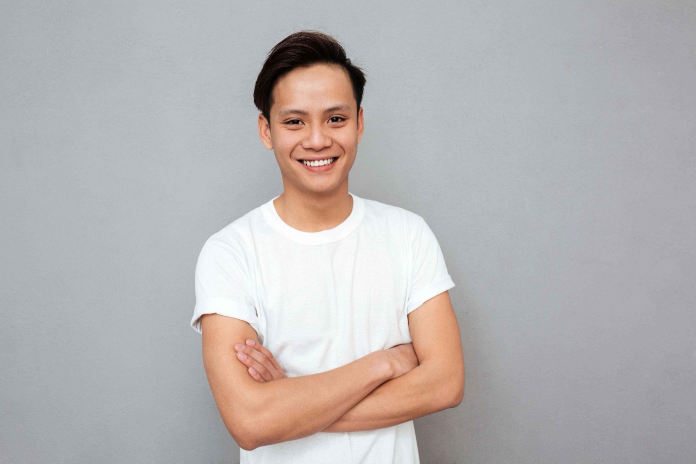 Team member in a white t-shirt with arms crossed