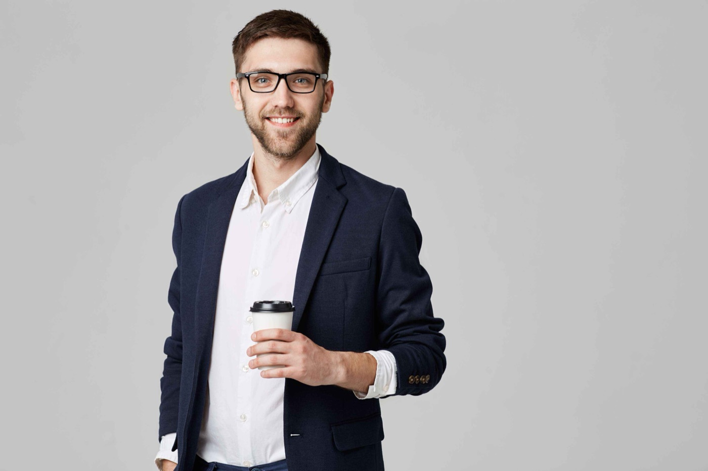 Team member in glasses holding a coffee cup