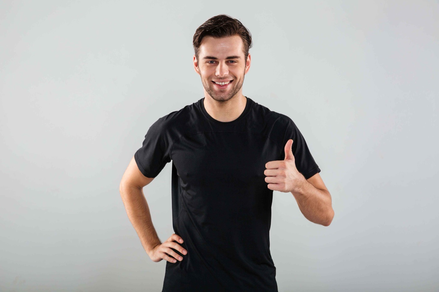 Team member in a black t-shirt giving a thumbs up